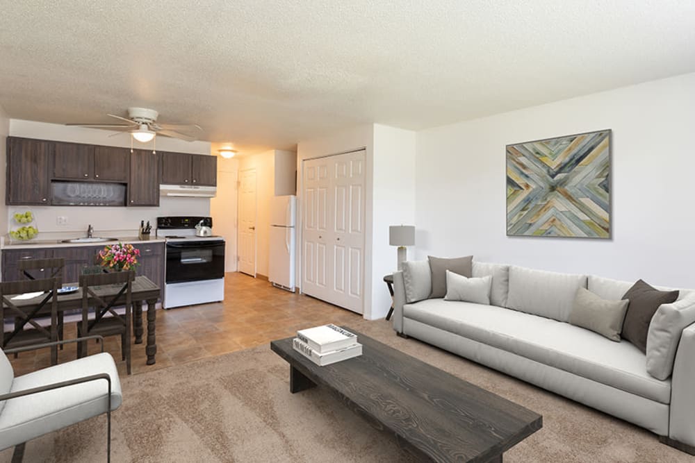 Elegant model living room and dining area at Hilton Village II Apartments in Hilton, New York