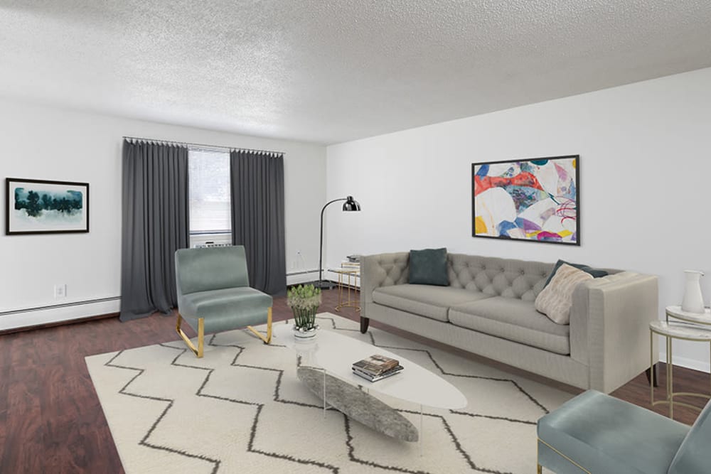 Spacious model living room with vinyl plank flooring at Hilton Village II Apartments in Hilton, New York