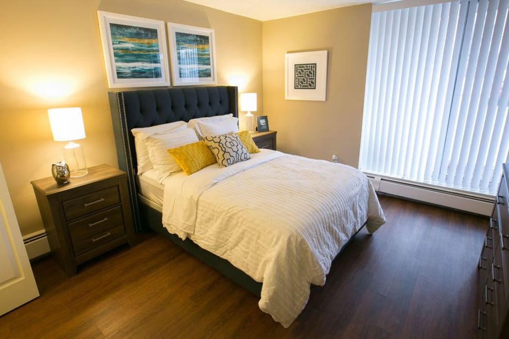 Large model bedroom with plank flooring at Solon Club Apartments in Oakwood Village, Ohio