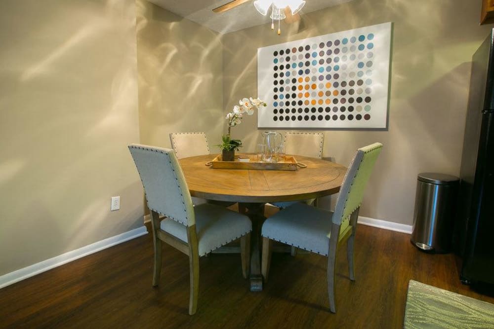 Dining area with vinyl plank flooring in a model home at Solon Club Apartments in Oakwood Village, Ohio