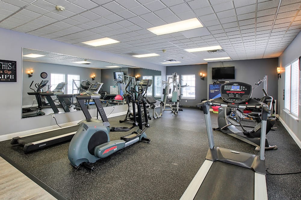 Fitness center with cardio and strength training equipment at Westview Commons Apartments in Rochester, New York
