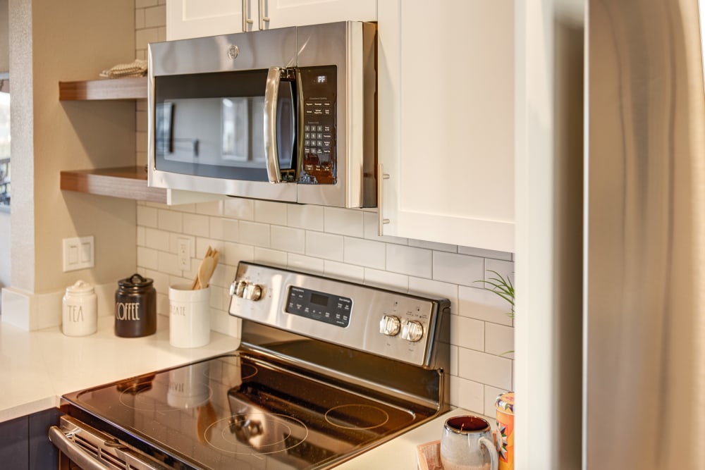 Subway tile backsplash and stainless-steel appliances in a model home's kitchen at Harbor Point Apartments in Mill Valley, California