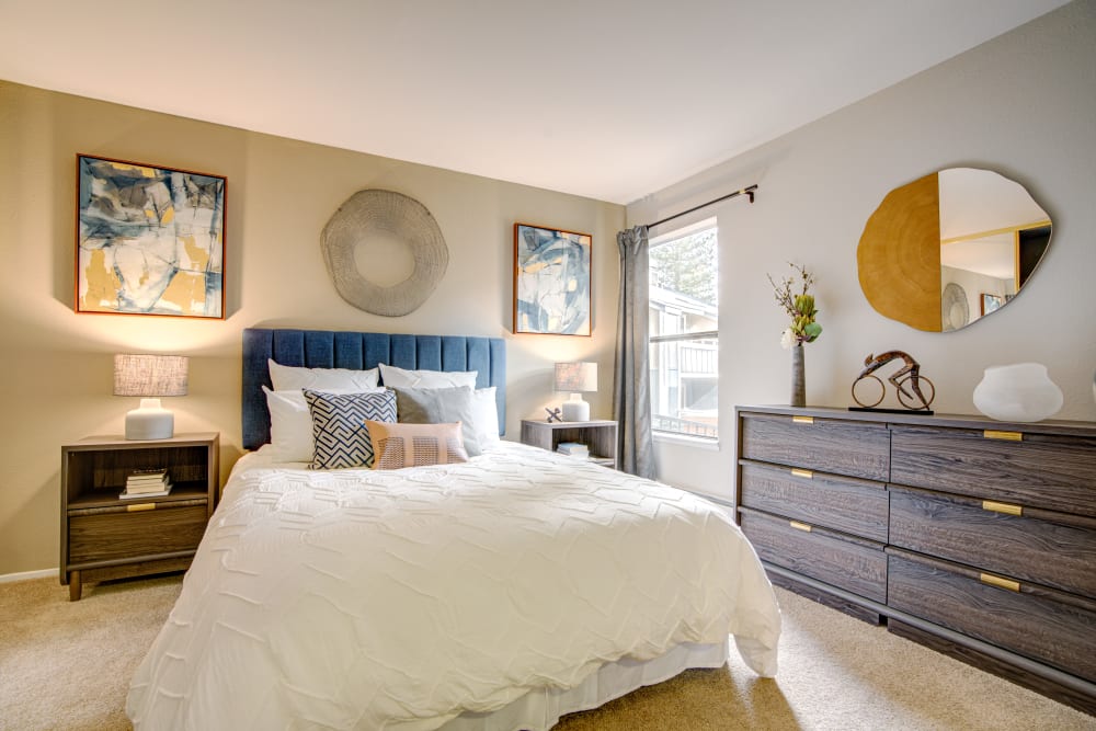 Accent wall and modern furnishings in a model home's master bedroom at Terra Martinez in Martinez, California