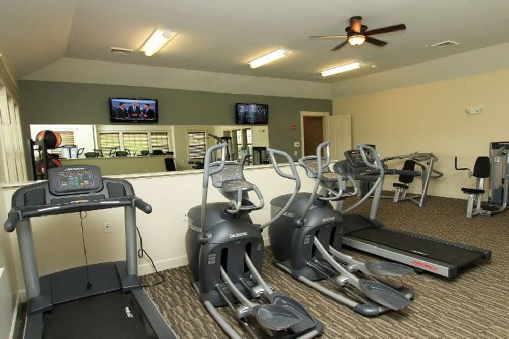 Well equipped fitness center with cardio equipment at Preserve at Autumn Ridge in Watertown, New York.