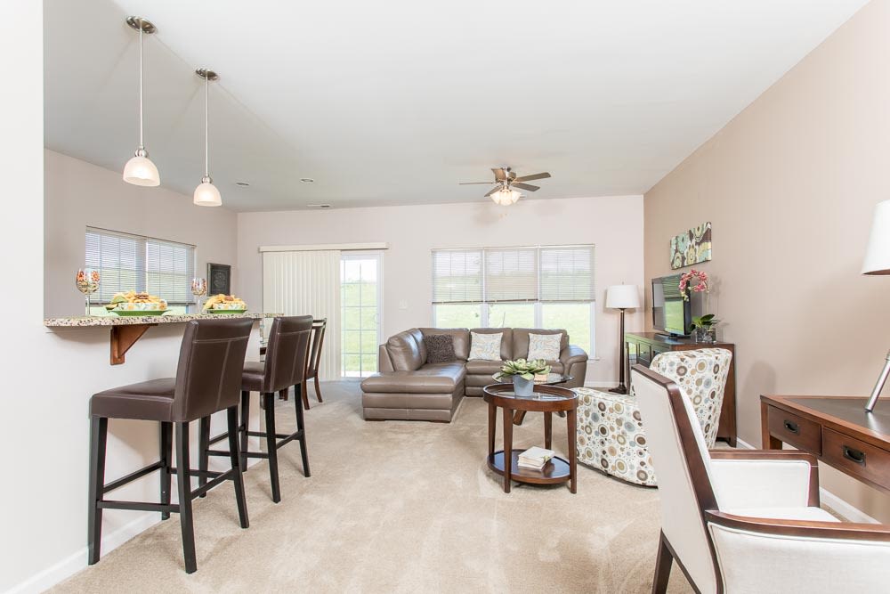 Model living room with bar at Preserve at Autumn Ridge in Watertown, New York.