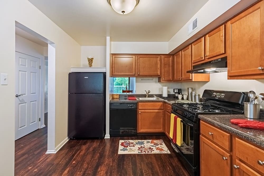 Model kitchen with black appliances at The Cascades Townhomes and Apartments in Pittsburgh, Pennsylvania