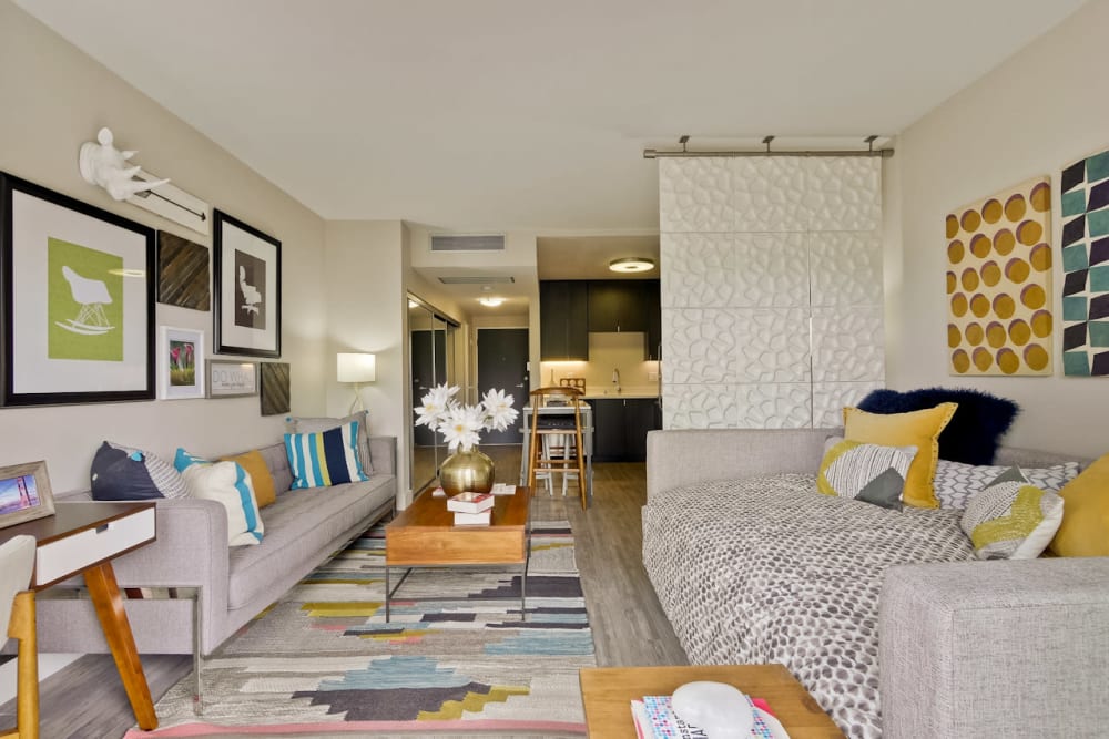 Hardwood floors in the open-concept layout of a model studio apartment at Mia in Palo Alto, California