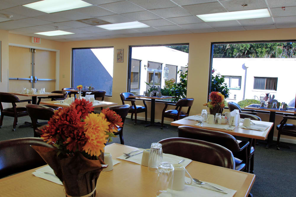 A large dining space with windows to let in natural light at Bradenton Oaks in Bradenton, Florida