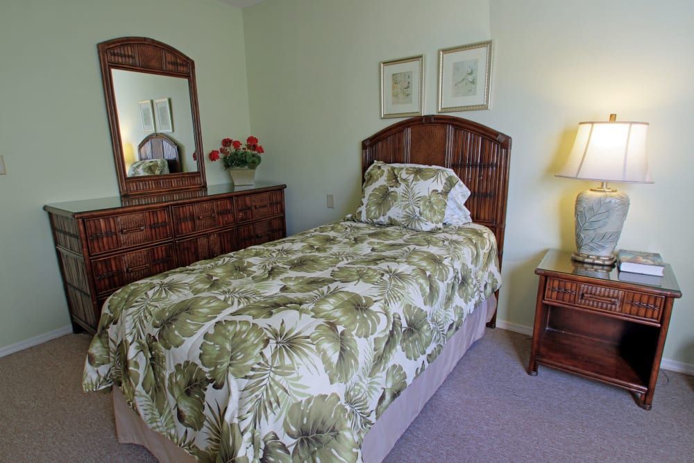 A bedroom with tropical themed decor at Bradenton Oaks in Bradenton, Florida