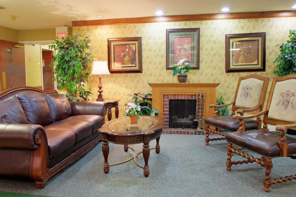 A lovely seating area complete with a fireplace at Forest Oaks of Spring Hill in Spring Hill, Florida