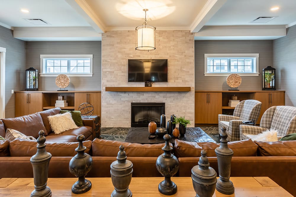 Beautiful clubhouse with seating and fireplace at Woodland Acres Townhomes in Liverpool, New York