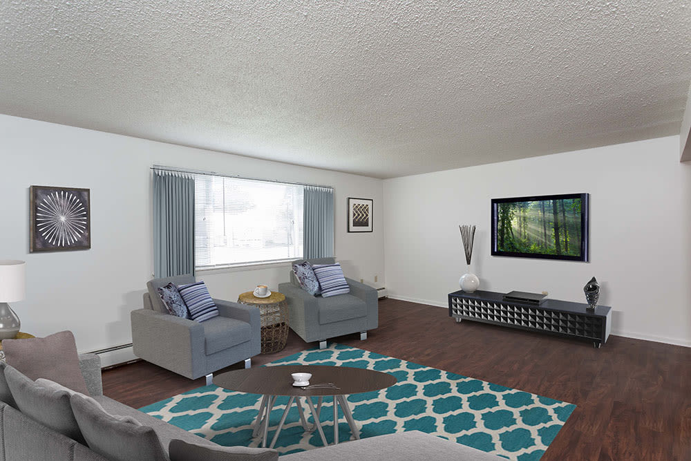 Bright, cozy living room at Perinton Manor Apartments in Fairport, New York