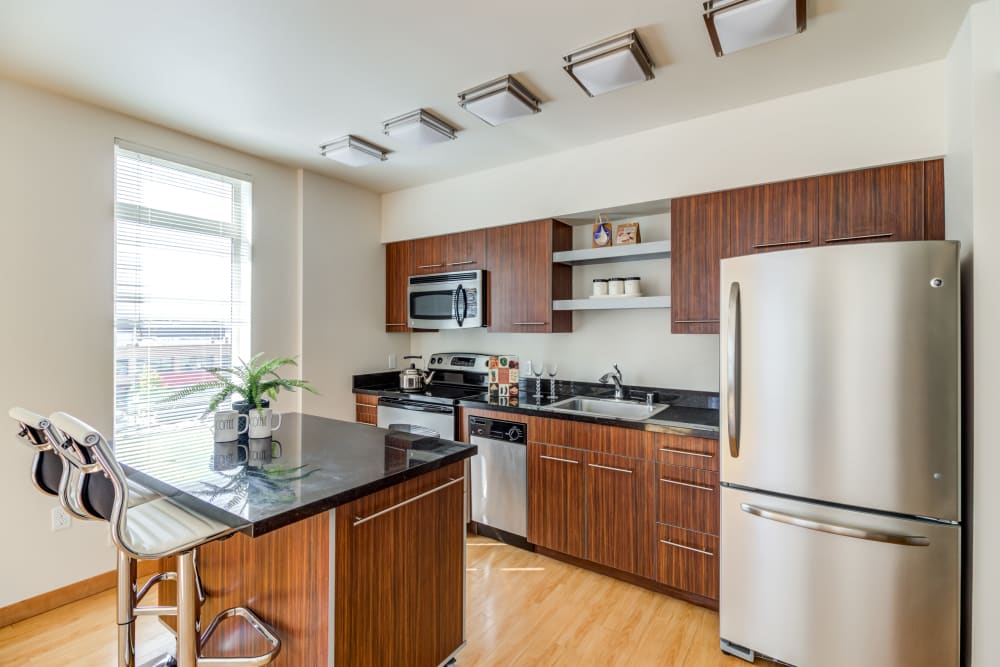 Kitchen with stainless steel appliances at The 101 in Kirkland, Washington