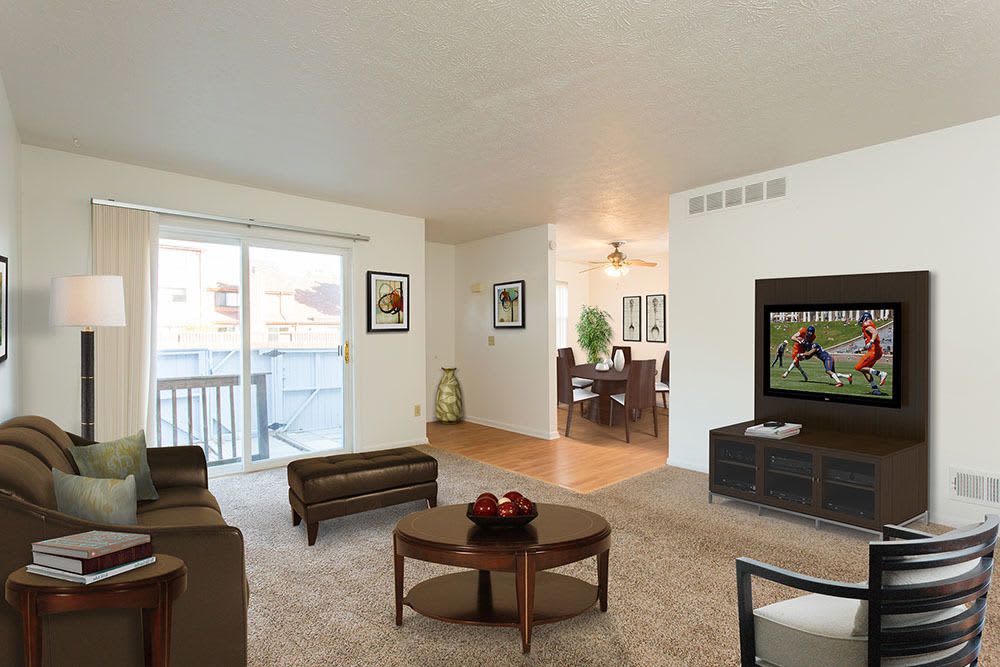 Model living room opening onto a private patio at Brighton Colony Townhomes in Rochester, New York