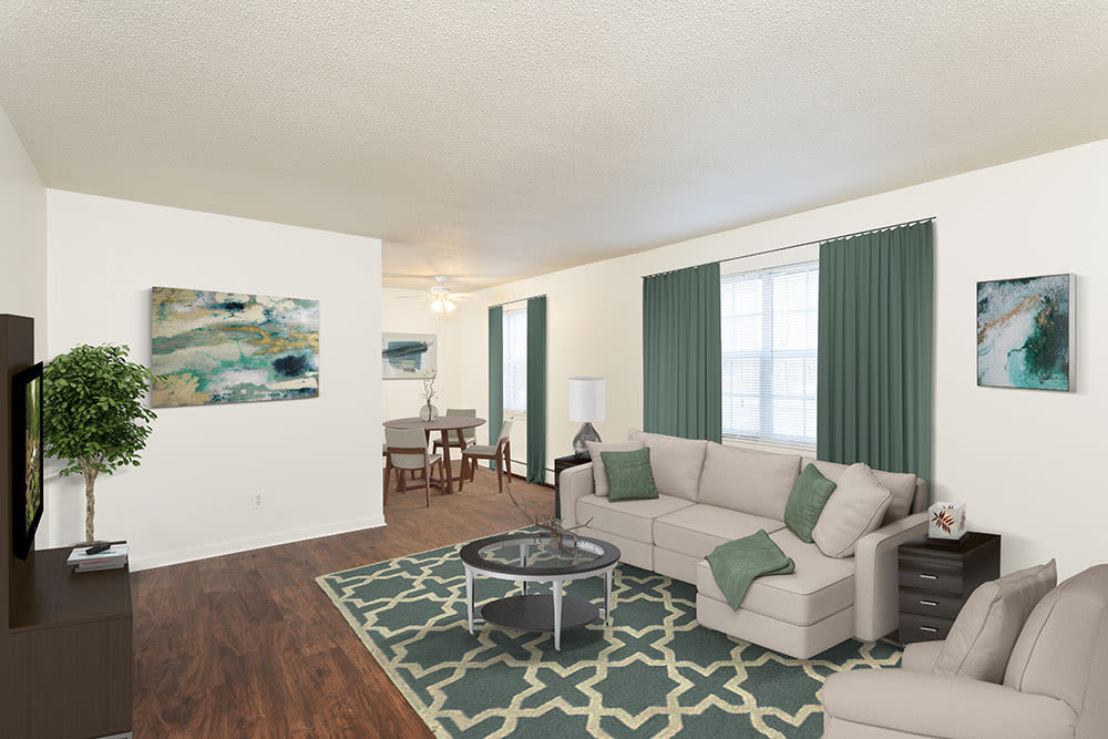 Spacious living room with vinyl plank flooring at Penfield Village Apartments in Penfield, New York