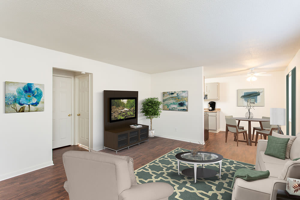Open concept living room and dining area at Penfield Village Apartments in Penfield, New York