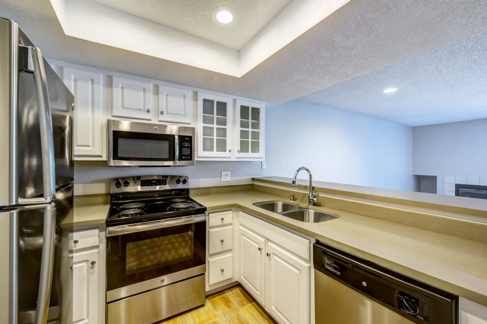 Ample cupboard space and recessed lighting in a model home's kitchen at Sofi Irvine in Irvine, California