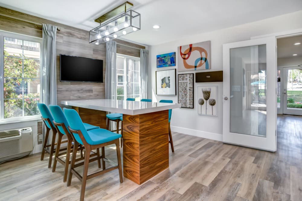 Bar seating and a flatscreen TV in the clubhouse at Sofi at Los Gatos Creek in San Jose, California