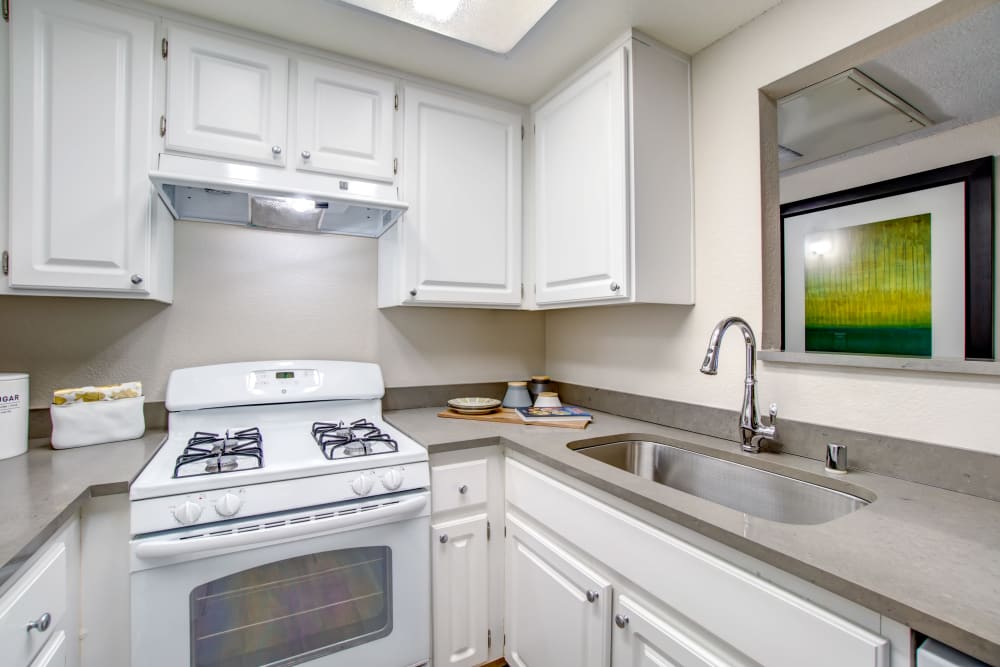 Modern kitchen with ample cupboard space and a gas range in a model home at Vue Fremont in Fremont, California