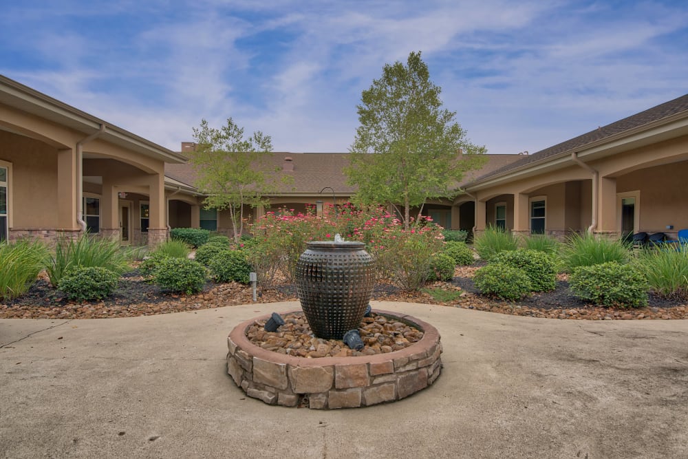 An outdoor water feature and landscaping at Pelican Bay in Beaumont, Texas