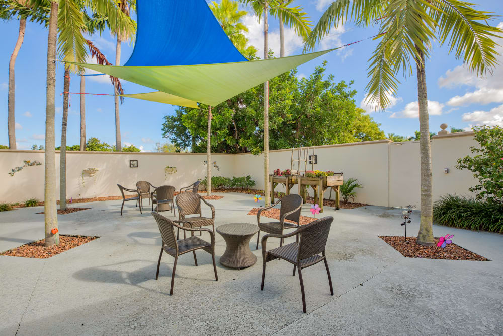 Sunny outdoor seating at The Peninsula Assisted Living & Memory Care in Hollywood, Florida