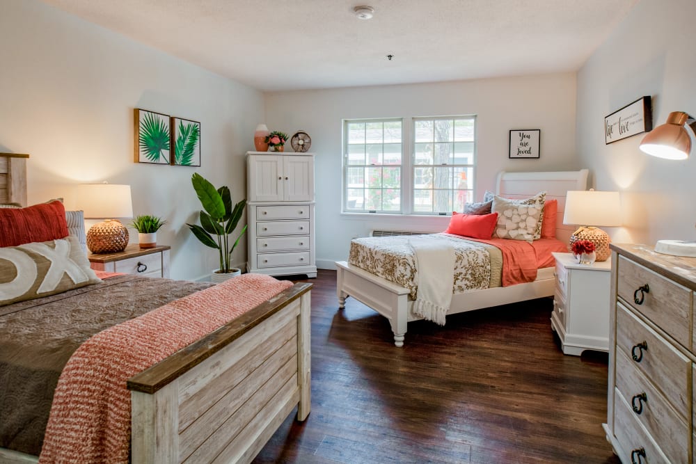 Room with two beds and a dresser in a large bedroom at Wood Haven in Tewksbury, Massachusetts