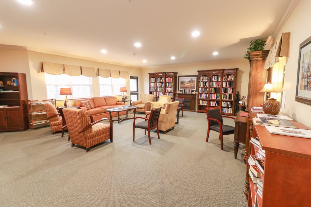 A spacious community area with fully stocked bookcases at The Crossings at Bon Air in Richmond, Virginia