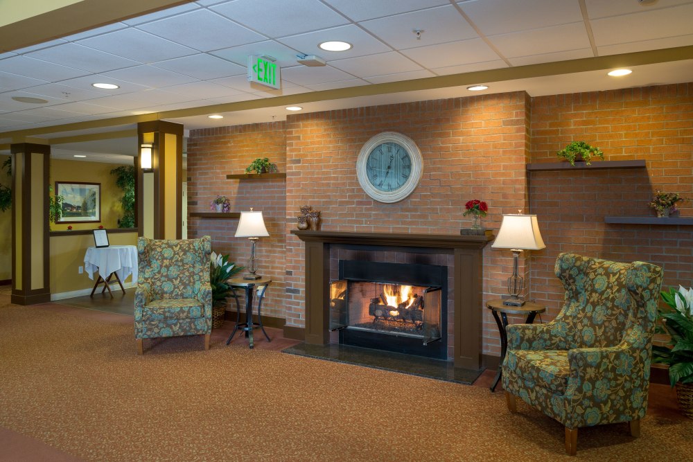 A fireplace in a visiting area at The Reserve at East Longmeadow in East Longmeadow, Massachusetts