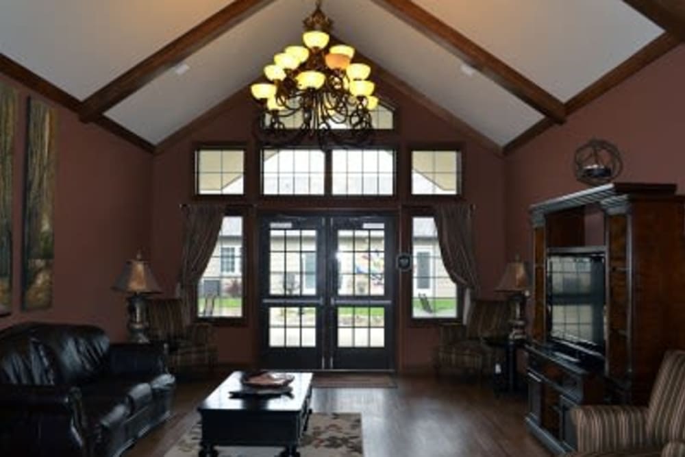 Community lounge with ample seating and a tv at Villas of Holly Brook Shelbyville in Shelbyville, Illinois