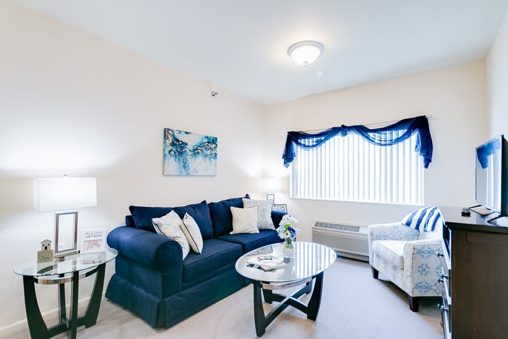 Living room layout with blue accents at Brentwood at Hobart in Hobart, Indiana