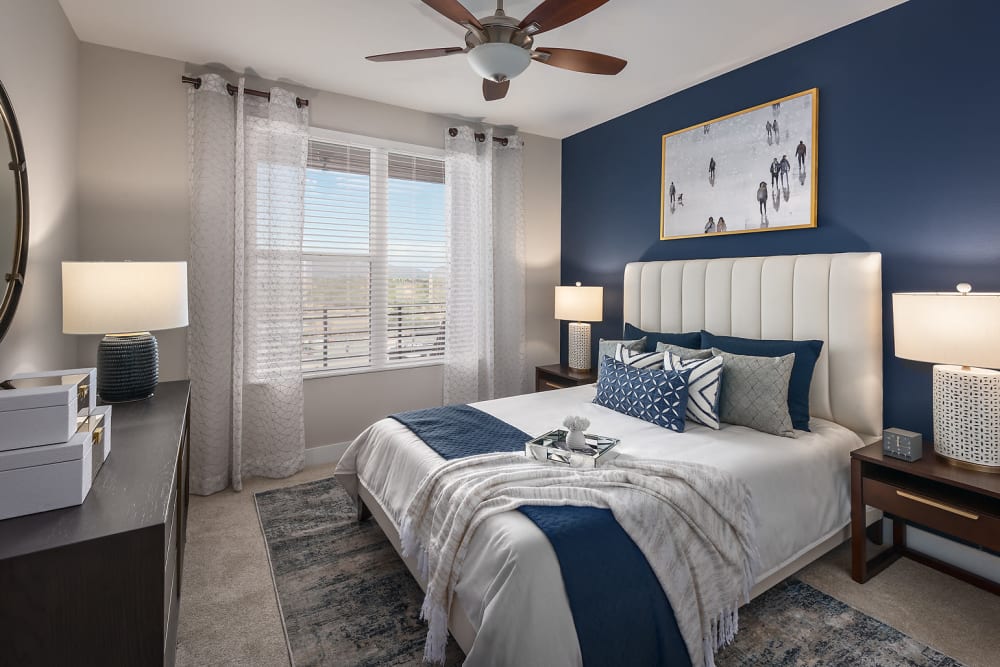 Large primary bedroom with beautiful furnishings in a model home at The Halsten at Chauncey Lane in Scottsdale, Arizona