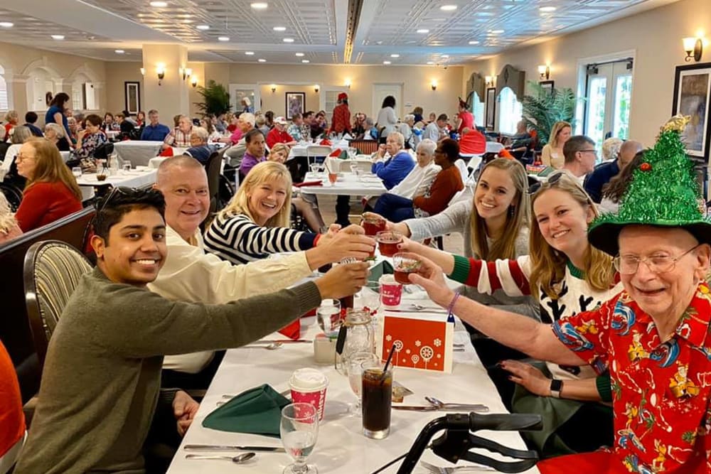 A group of staff and a resident having fun at an event at Inspired Living Ocoee in Ocoee, Florida. 