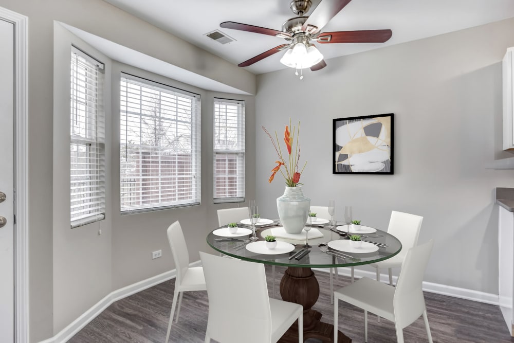 An apartment dining room with ceiling fan and hardwood floors at Lakeview Townhomes at Fox Valley in Aurora, Illinois
