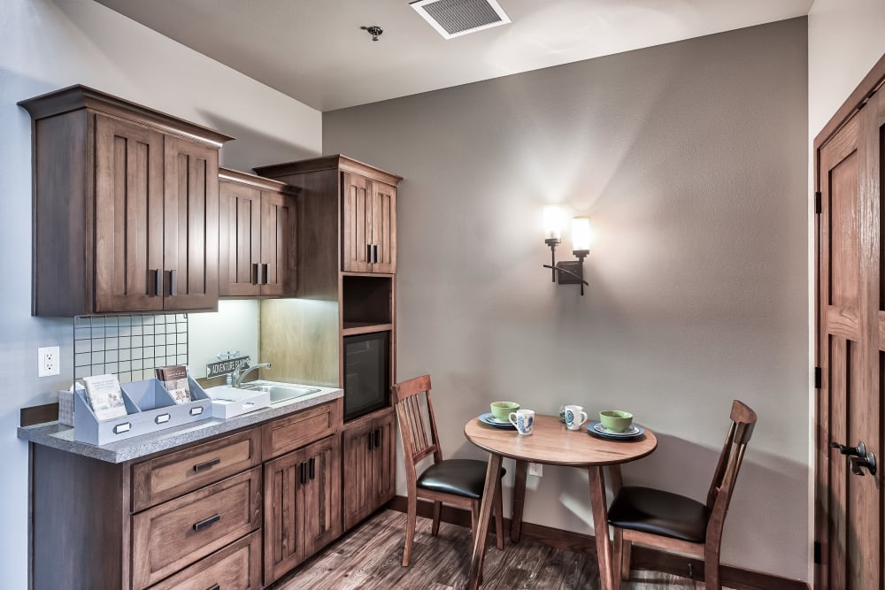 A kitchen and dining room area in an apartment at The Landings of Kaukauna in Kaukauna, Wisconsin