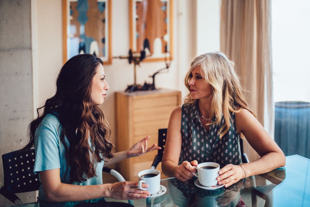 Residents chatting over coffee in the clubhouse at EVIVA Midtown in Sacramento, California