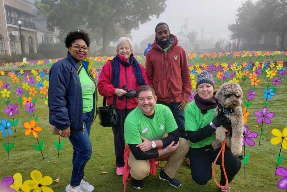 A group of staff and a resident having fun at an outing near Inspired Living Alpharetta in Alpharetta, Georgia. 