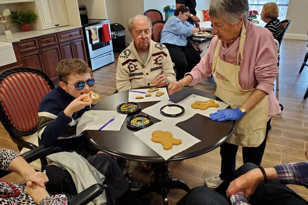 Residents and family members eating cookies at Inspired Living Alpharetta in Alpharetta, Georgia. 