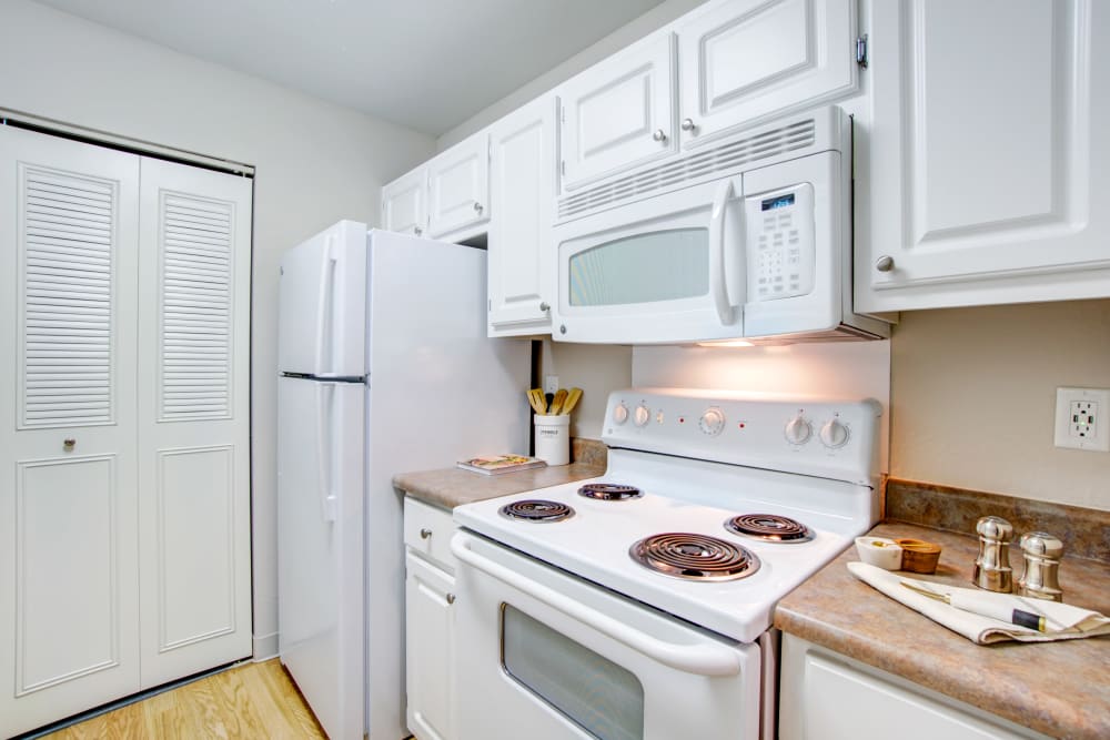 Modern kitchen with a pantry and ample cupboard space in a model home at Waterstone Fremont in Fremont, California