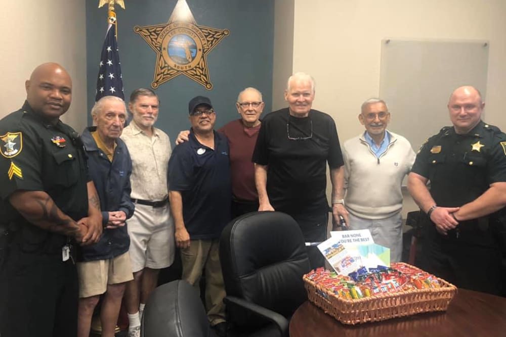 Residents and staff taking a picture with local police officers at Inspired Living Bonita Springs in Bonita Springs, Florida. 