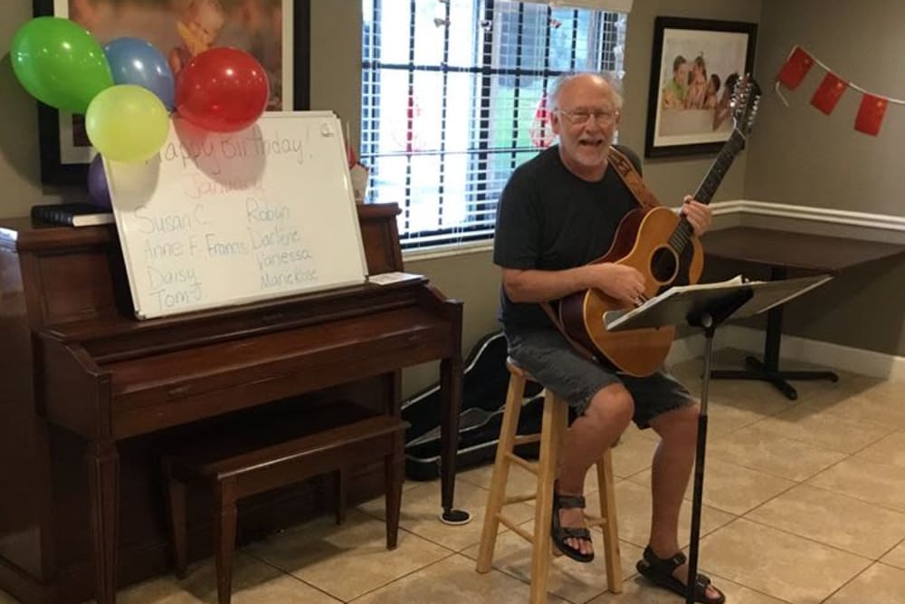 A resident playing the guitar at Inspired Living Hidden Lakes in Bradenton, Florida. 