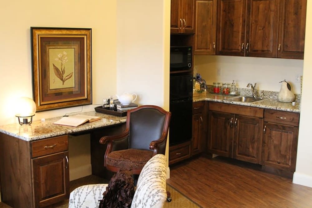 A desk and kitchen in an apartment at The Retreat at Sunriver in St. George, Utah
