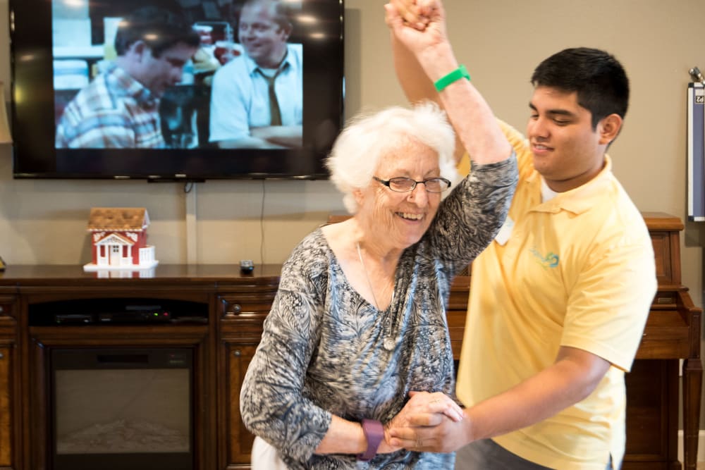 Staff member dancing with a resident at Inspired Living Kenner in Kenner, Louisiana. 