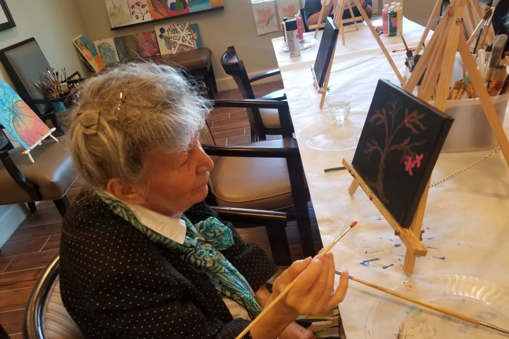 A resident making a painting at Inspired Living Lakewood Ranch in Bradenton, Florida