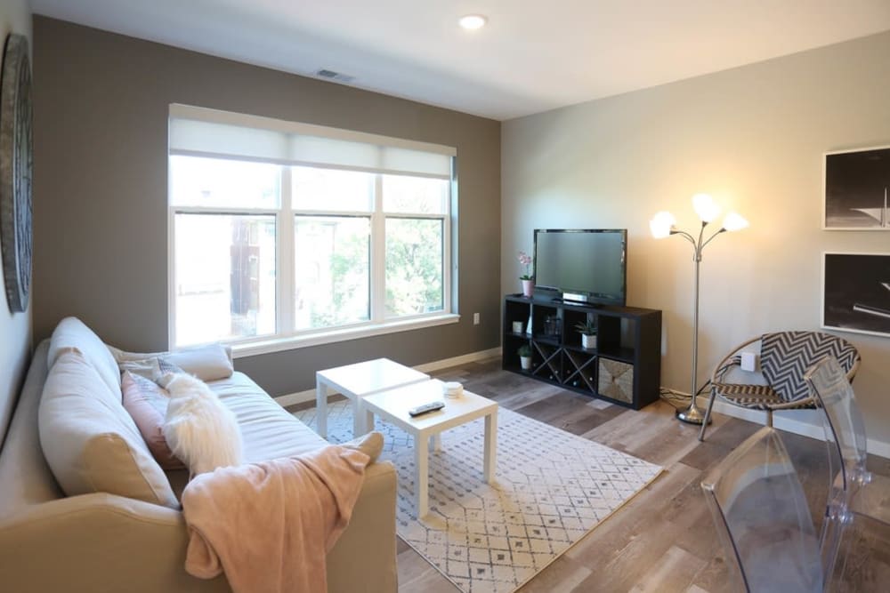 Spacious living room with wood-style flooring at Tribeca in St. Louis, Missouri
