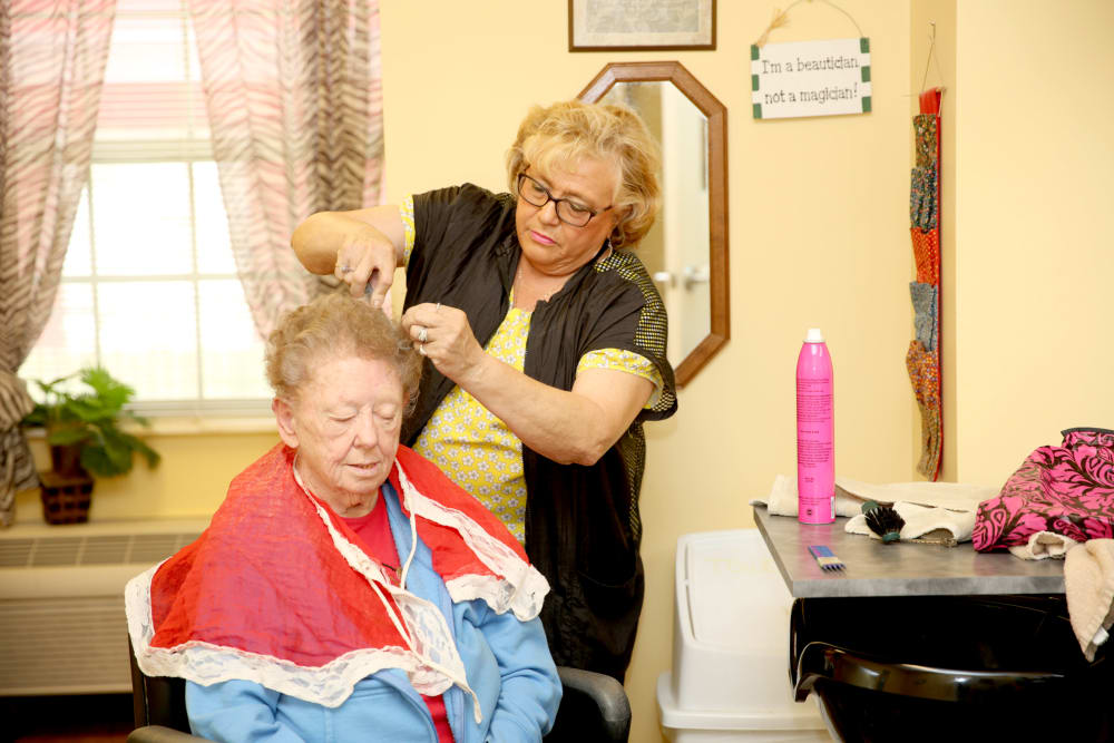 A staff member doing a resident's hair at Providence Assisted Living in Grenada, Mississippi. 