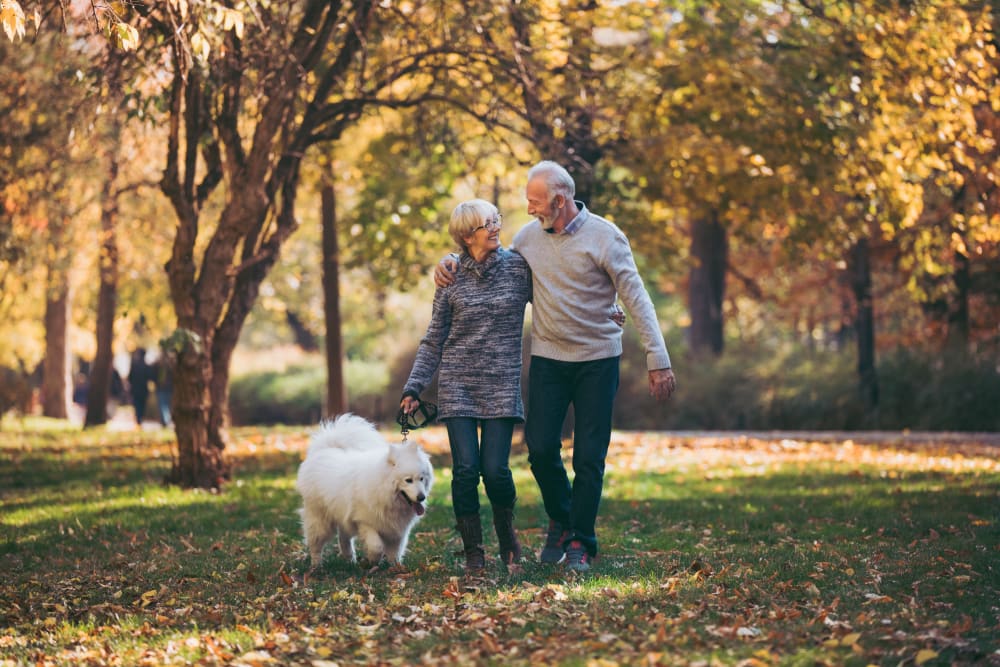 Couple walking their dog in a park near 301 Riverwalk Place in Buffalo Grove, Illinois