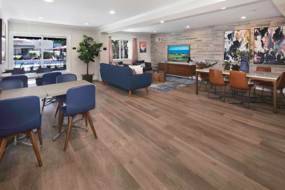Resident clubhouse interior with hardwood flooring and modern furnishings at Haven Warner Center in Canoga Park, California