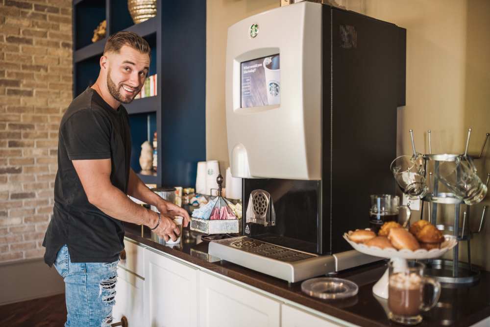 Resident using the coffee bar in the clubhouse at Springfield Apartments in Murfreesboro, Tennessee