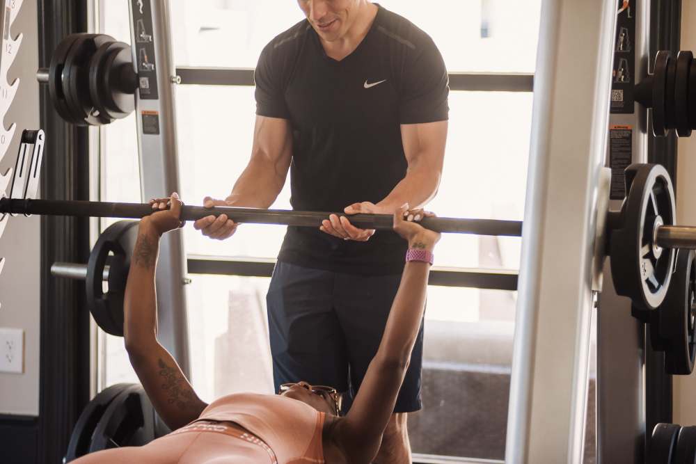 Resident bench pressing in the fitness center at Springfield Apartments in Murfreesboro, Tennessee
