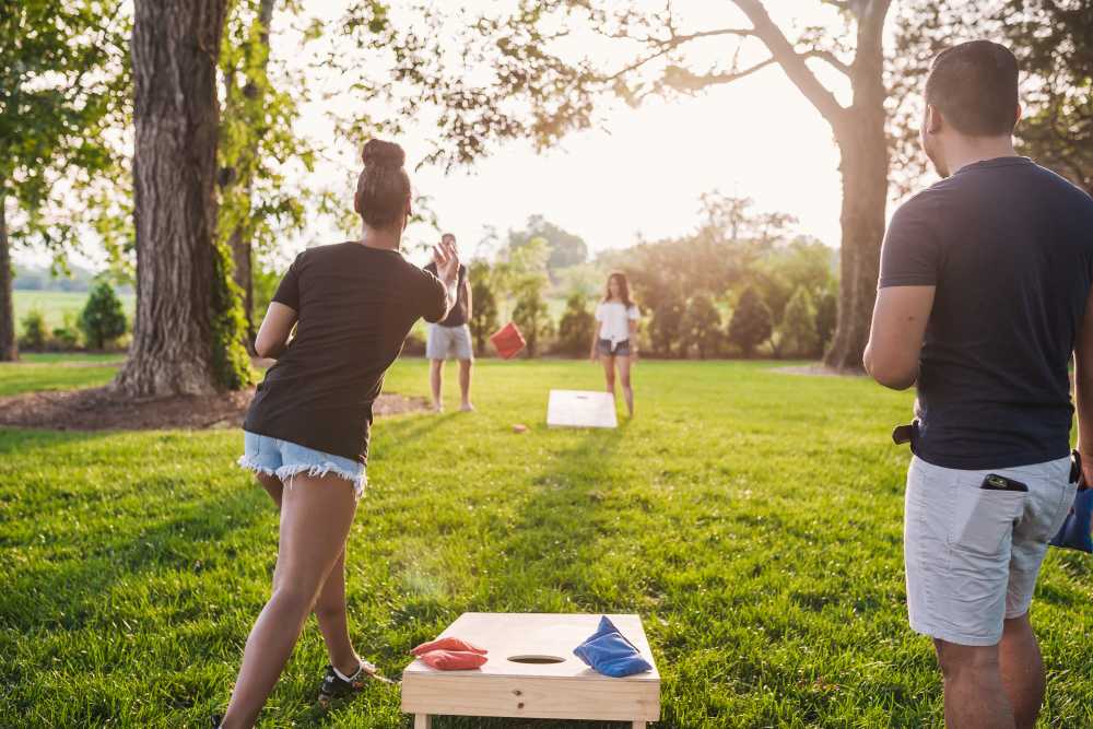 Residents playing cornhole on the lawn at Springfield Apartments in Murfreesboro, Tennessee